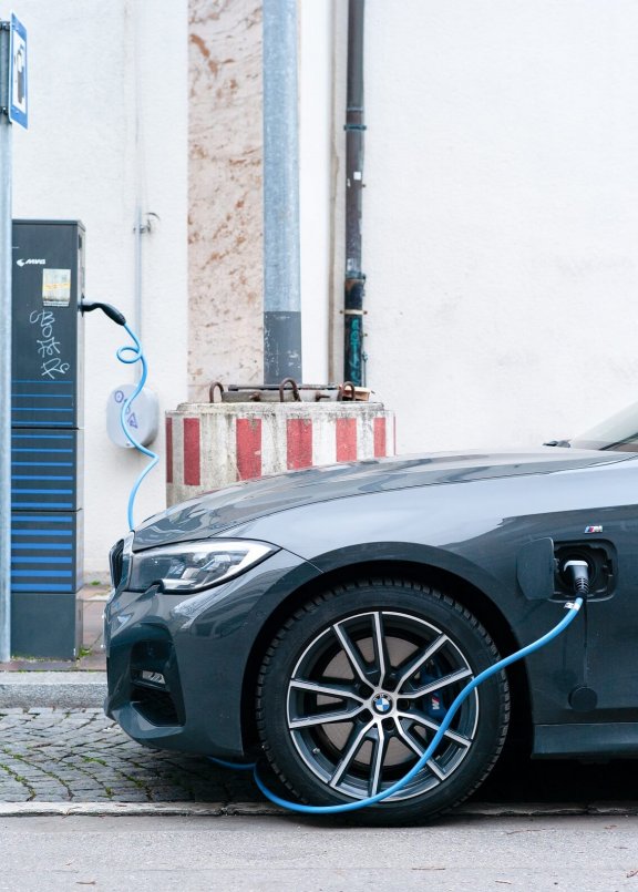 Electric car connected to the charging station by cable