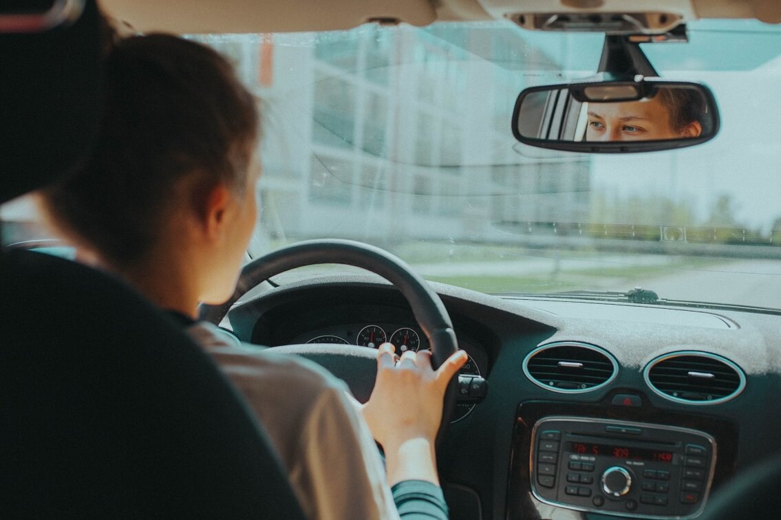 Young woman at the wheel of her car