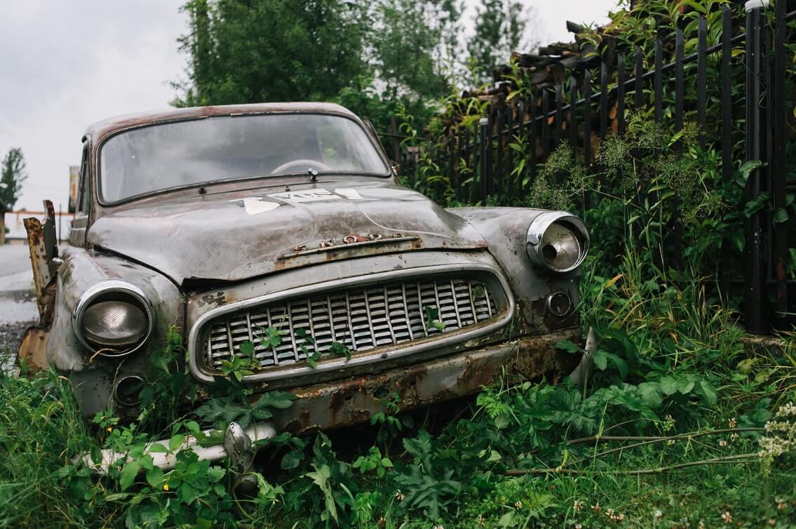 old, rusty car at the roadside