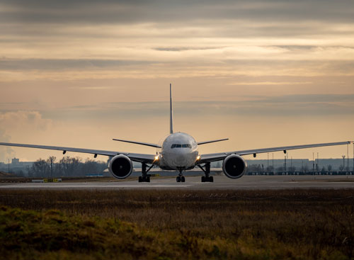 A large aeroplane is taxiing on the tarmac at the airport