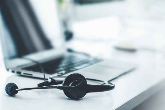 Headset next to a laptop