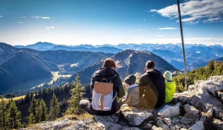 Family sitting on a mountain top