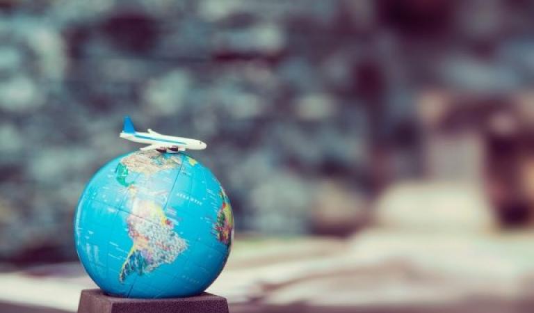 Globe with toy plane - Travel &amp; park on holiday again