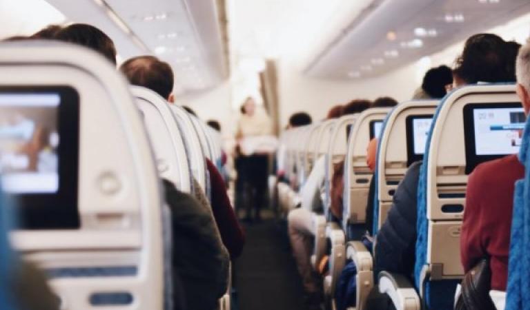 Passengers on the plane - What to consider when travelling during Corona