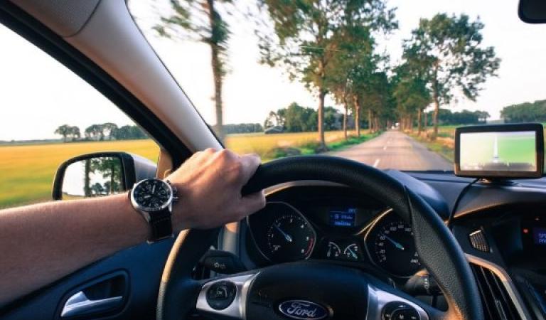 Motorist driving on a country road - driving fun in summer