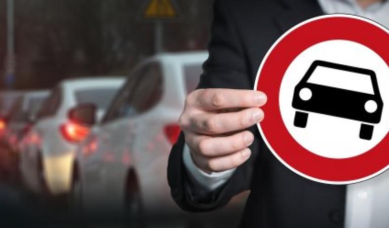 Man with prohibition sign for motor vehicles, other multi-lane vehicles